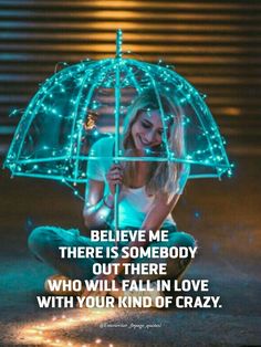 a woman sitting on the ground holding an umbrella with lights around her and saying, believe me there is somebody out there who will fall in love with your kind of crazy