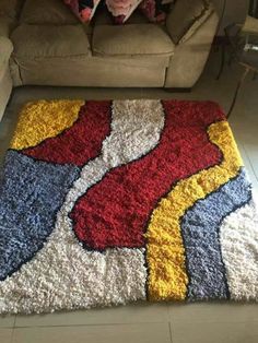 a living room with a couch and rug on the floor