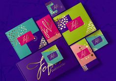 four different colored greeting cards on a purple background