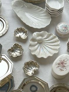 a table topped with lots of different types of plates and bowls next to each other