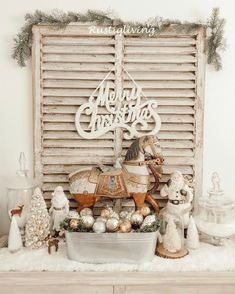 an old window with christmas decorations on it and a horse figurine in the center