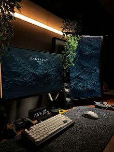 a computer monitor sitting on top of a desk next to a keyboard