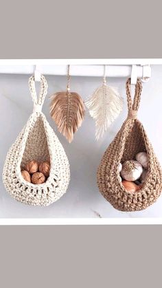 three baskets hanging from hooks with shells in them