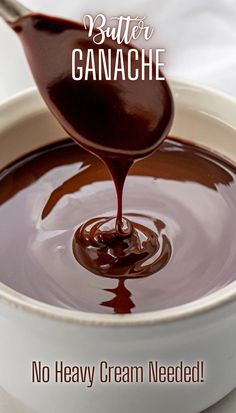 a spoon full of chocolate sauce with the words butter ganache on it