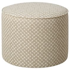 a round ottoman that has an intricate pattern on it