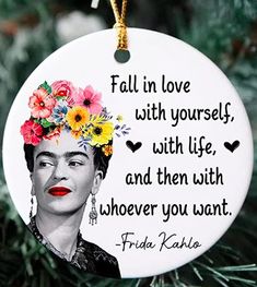 frida kaloso quote ornament hanging from a christmas tree with flowers on it