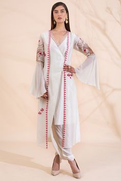 Off white asymmetric kurta with attached embroidered long jacket. Comes with matching dhoti pant.
Components: 2
Neckline: V neck
Sleeve Length: Bell sleeves
Fabric: Chanderi, Silk Crepe
Color: Off white
Cutwork,Pearl,Sequin
Asymmetric hemline
Overlap style - Aza Fashions Varun Bahl, Kurta Set For Women, White Kurta, Contemporary Wardrobe, Net Dupatta, Indian Fashion Designers, Kurta With Pants, Pernia Pop Up Shop, Kurta Set