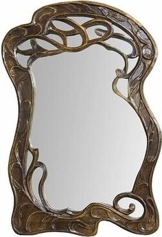 a mirror that is sitting on top of a wooden table with an intricate design around it