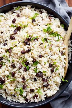 a bowl filled with rice and beans on top of a wooden table