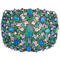 A stunning bracelet handmade in 18K gold and sterling silver. It is set in 22.21 carats emerald, 10.94 carats opal doublet, tanzanite and 3.25 carats diamonds. Pair this with your favorite evening dress for a red carpet look. Clasp Closure FOLLOW MEGHNA JEWELS storefront to view the latest collection & exclusive pieces. Meghna Jewels is proudly rated as a Top Seller on 1stDibs with 5 star customer reviews. All items manufactured by us are handmade and can be customized or redesigned. Composition Diamond Cuff Bracelet, Vintage Cuff Bracelet, Gold Horns, Red Carpet Look, Wide Cuff Bracelets, Tanzanite Diamond, Sparkly Jewelry, Gold Bracelet Cuff, Bracelet Cuff