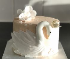 a cake decorated with a swan and flowers