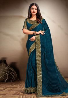 Teal satin silk festival wear saree 354E  Desc:  Color : Teal Fabric : Silk Satin Work : Embroidery Wash Care : Dry clean Sleeve Style : Half Sleeve Long Sleeves : Done only in Custom Stitch Sleeves Lining : Done only in Custom Stitch Bust Size : 32 to 42 Inches Occasion : Wedding   Festival   Christmas   Sangeet   Party Wear   Engagement   Reception. With Express Free Shipping and Custom Stitching, Buy Indian Wedding Party Wear Saree Teal satin silk festival wear saree 354E online in USA, UK an Luxury Saree With Peacock Design For Festive Occasions, Party Wear Indian Dresses Kollybollyethnics, Affordable Bollywood Style Saree With Pallu, Cheap Festive Saree With Zari Work, Cheap Fitted Saree For Festive Occasions, Cheap Bollywood Saree With Pallu, Cheap Festive Saree Traditional Wear, Cheap Festive Saree With Motifs, Affordable Zari Work Saree For Festivals