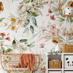 a baby's room decorated with floral wallpaper