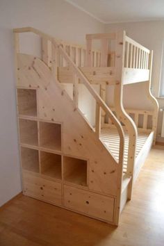 there is a wooden bunk bed with stairs in the room next to it and a bookcase below