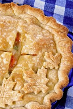 an apple pie on a blue and white checkered table cloth