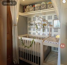 a baby crib in the corner of a room with curtains and lights on it