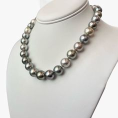 Step into a world of refined allure and grace with this exquisite Tahitian pearls necklace that radiates an undeniable sophistication. Meticulously crafted to perfection, it effortlessly captures attention with its captivating the mix of light pastel hues - golden, silver, light green, and light blue,- emitting a gentle and soothing glow that lends an aura of tranquility to any occasion. This resplendent necklace is finished with rhodium-plated 14K white gold lobster clasp, adorned with tiny dia Luxury Tahitian Pearl Round Bead Necklace, Elegant Single Strand Tahitian Pearl Necklace, Elegant Tahitian Pearl Jewelry With Round Beads, Elegant Tahitian Pearl Necklace For Formal Occasions, Elegant Tahitian Pearl Necklace With High Luster, Luxury Single Strand Tahitian Pearl Necklace, Luxury Tahitian Pearl Single Strand Necklace, Luxury Tahitian Pearl Necklace For Formal Occasions, Luxury Tahitian Pearl Necklace With Round Beads