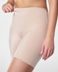 A low-profile shaping short designed to prevent visible panty lines and inner thigh chafing. In a sleek fabric that delivers firm support to your front—with a low back that stays invisible under your most scene-stealing styles. Featuring a stay-put silicone strip at the waistband that won't roll. | Spanx Women's Suit Your Fancy Shaping Low Back Mid-Thigh Shorts Fitted Shorts With Built-in Bra, Mid-thigh Length, Fitted Elastane Shorts With Smoothing Details, Fitted Smoothing Mid-thigh Shorts, Compressive Short-length Elastane Shapewear, Compressive Shapewear With Short Leg, Compressive Elastane Shapewear Short Length, Fitted Seamless Short Shapewear, Seamless Fitted Short Shapewear, Fitted Shapewear Boxer Briefs Short Length