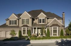 a large house with lots of windows and bushes