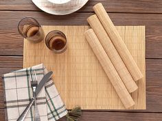 placemats, napkins and utensils laid out on a wooden table