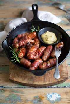 sausages in a skillet with mustard and herbs