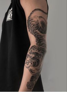 a man with a tiger tattoo on his arm