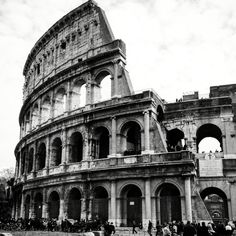 an old building with people standing around it