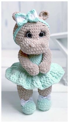 a crocheted teddy bear dressed in a dress