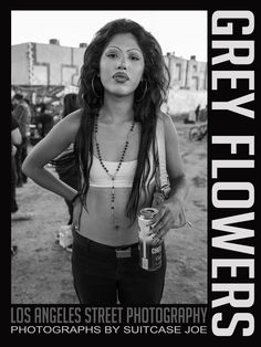 a black and white photo of a woman with her hands on her hips holding a drink