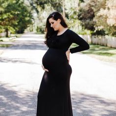 a pregnant woman in a long black dress