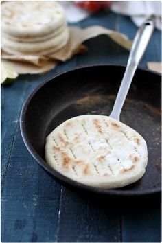 a skillet with some flat bread in it