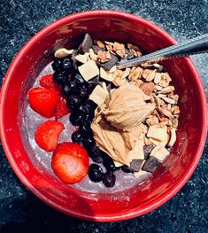 a red bowl filled with cereal and fruit