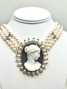 The cameo is an agate carved in the 1920s set in a modern 14k white gold and pearl necklace with sapphire accents. The setting is modern in 14 karat gold.  The gold weight is 15 grams and there are 48 diamonds with an approximate weight of .54 carats.  It is framed in white Akoya pearls about 6 mm.  The necklace is 3 strands of 6 mm ahoy pearls set with 14 karat white gold spacers and clasp.  The gold weight is 11 grams.  The diamond weight is approximately 1.16 carats and the natural Sapphires Cameo Necklace, Pearl Set, Akoya Pearls, Natural Sapphire, Pearl Necklace, Agate, Sapphire, White Gold, Jewelry Necklaces