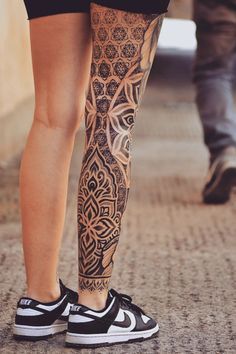 the legs and ankles of a woman with tattoos