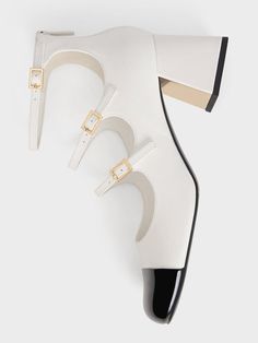 Embrace a clean and classic aesthetic with these Mary Jane pumps. They stand out with their striking white finish and triple buckled straps. Additionally, this pair features toe caps with a modern square shape in contrasting black patent, creating an eye-catching two-tone look. Perched atop flare block heels, these shoes are perfect for showcasing with shorter hemlines. The zippers at the back ensure effortless wear for any occasion. White Mary Jane Heels, Classic Aesthetic, White Pumps, Mary Jane Pumps, Charles Keith, Modern Square, Square Shape, Mary Janes, Block Heels