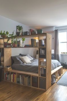 a bedroom with a bed, bookshelf and various plants on the shelves in it