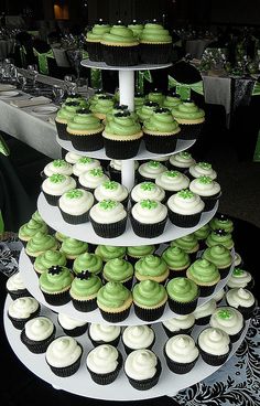 cupcakes are stacked on top of each other in the shape of a tree