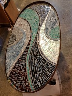 a toilet seat made out of mosaic tiles