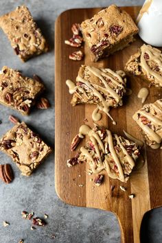 Five caramel glazed Blondies on a cutting board with three more unglazed Blondies on the counter next to them. Pancake Syrup, 9x13 Baking Dish, Caramel Flavoring, Toasted Pecans