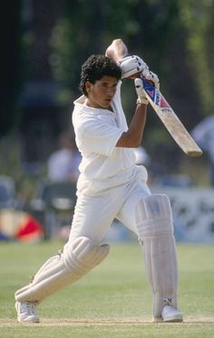 a man holding a cricket bat on top of a green field with the words practice makes you perfect everyday in any field