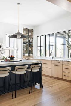 a kitchen with wooden floors and white walls