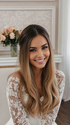 a woman sitting on top of a couch wearing a white dress and smiling at the camera