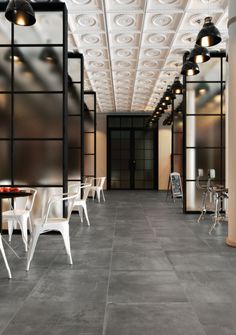 an empty restaurant with white chairs and tables