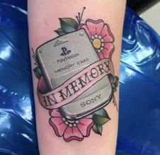 a woman's arm with a tattoo on it that says in memory and flowers