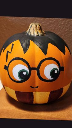 a pumpkin with glasses painted on it