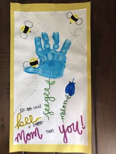 a child's handprint with the words bee mom on it and bees flying around