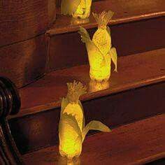 three yellow paper flowers sitting on top of some stairs next to a stair case with wooden steps