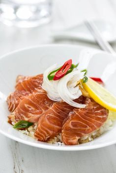 a white plate topped with fish and rice