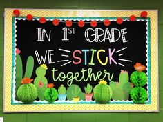 a sign that says in 1st grade we stick together with cacti and succulents