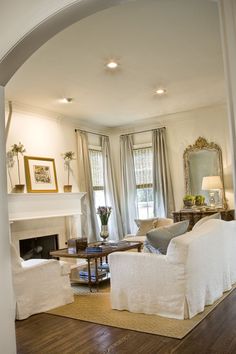 a living room filled with furniture and a fire place